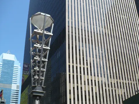 The diamond-shaped street lamps of West 47th Street against the Midtown towers on a clear day