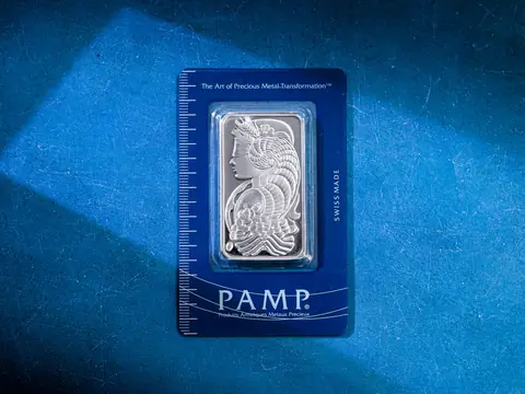 A silver bar in its assay card, its weight and fineness stamped on the face